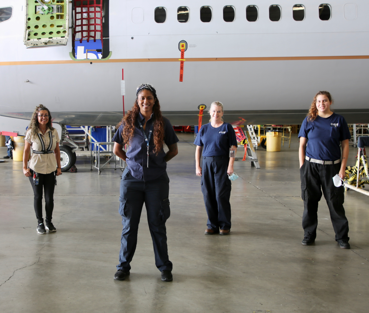Mechanics in front of an airplane Mechanics in front of an airplane